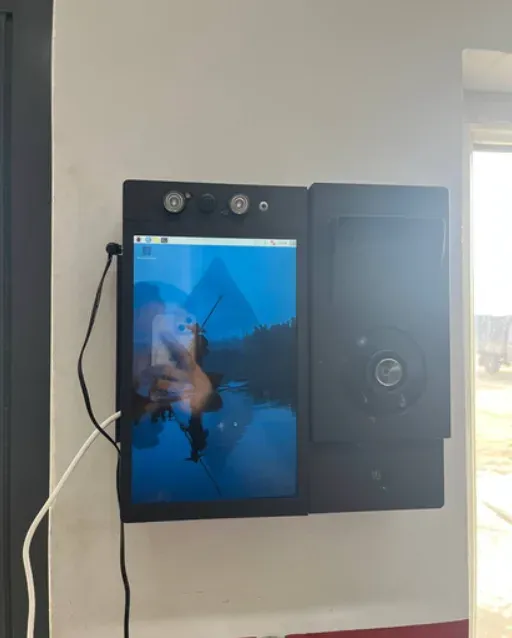 The AMS tablet installed on a wall with its sensors, a Raspberry Pi desktop on the screen